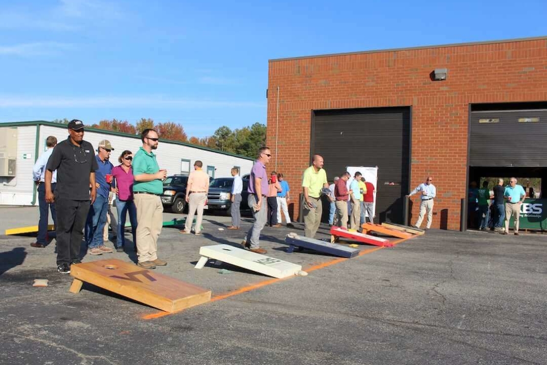 Six different groups playing cornhole for a tournament at the KBS "Bags Stew and Brew" event.